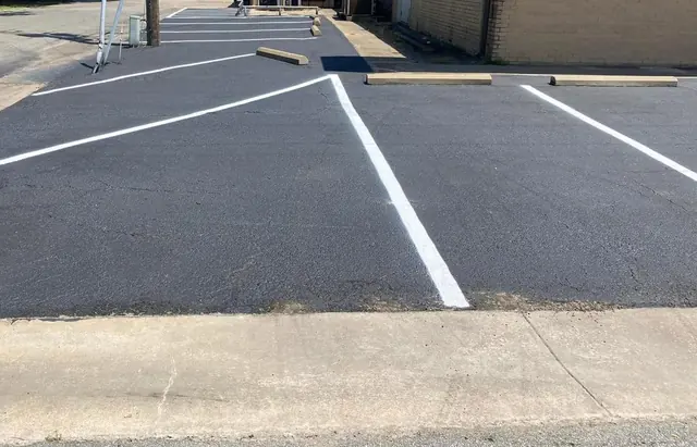 Striped asphalt access area beside a building